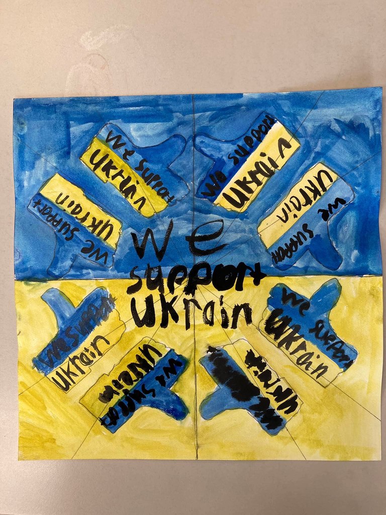Artwork of Ukraine's flag with the phrase, "We support Ukraine" written on it.